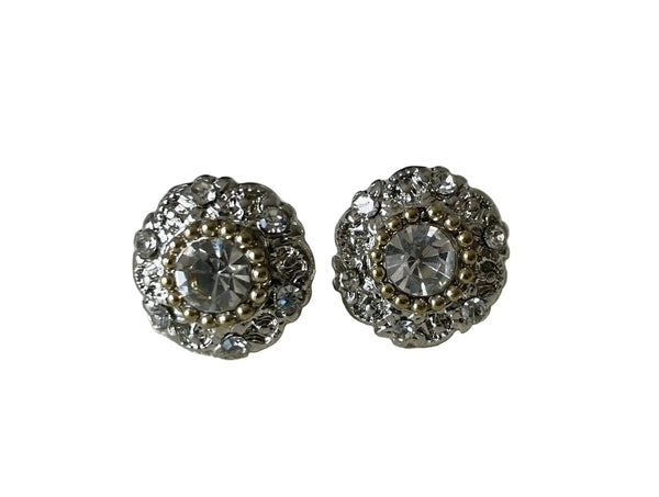 Pair of silver stud earrings with clear gemstones on a light gray background