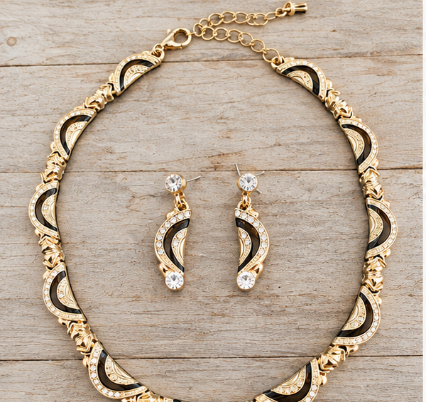 Vintage gold black choker necklace earrings set on pale barn wood